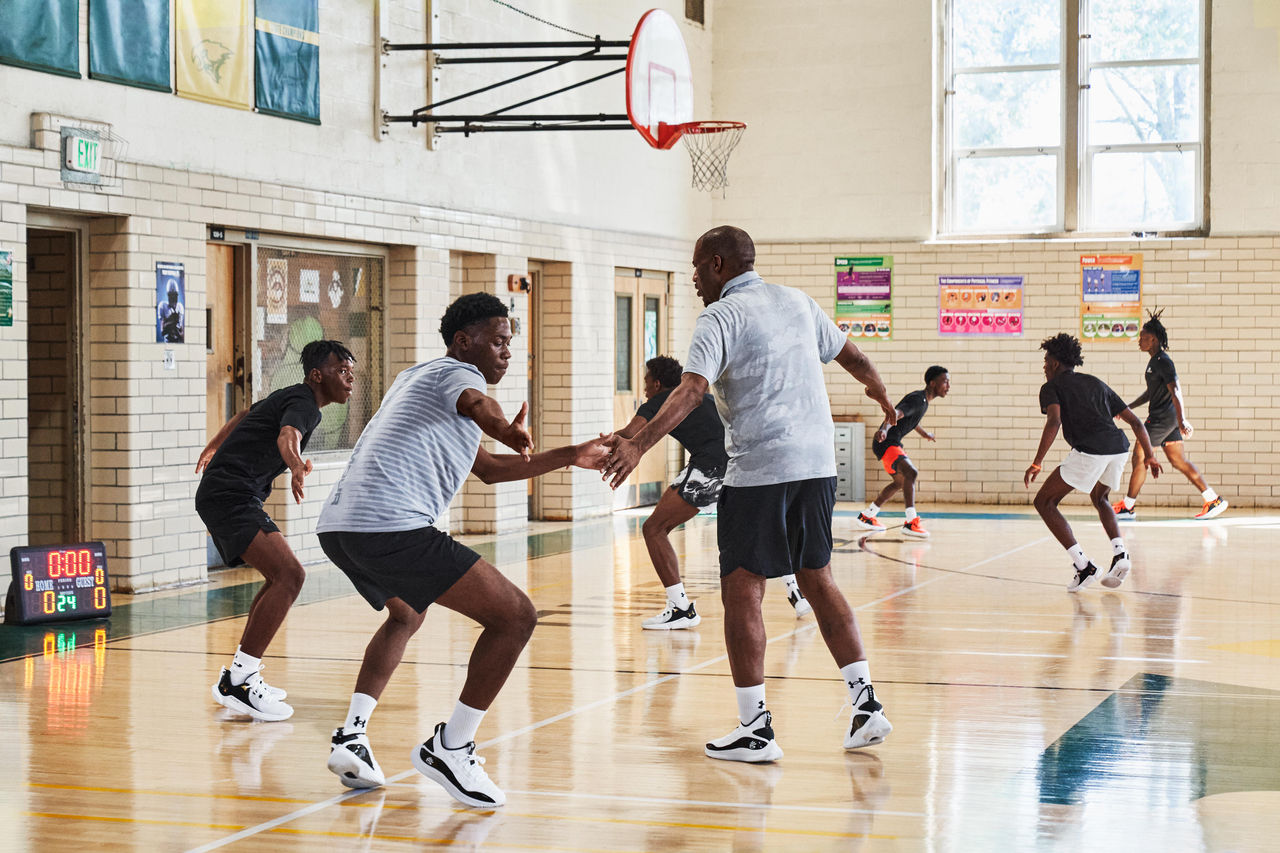 Coach Standing In Front of Basketball Players