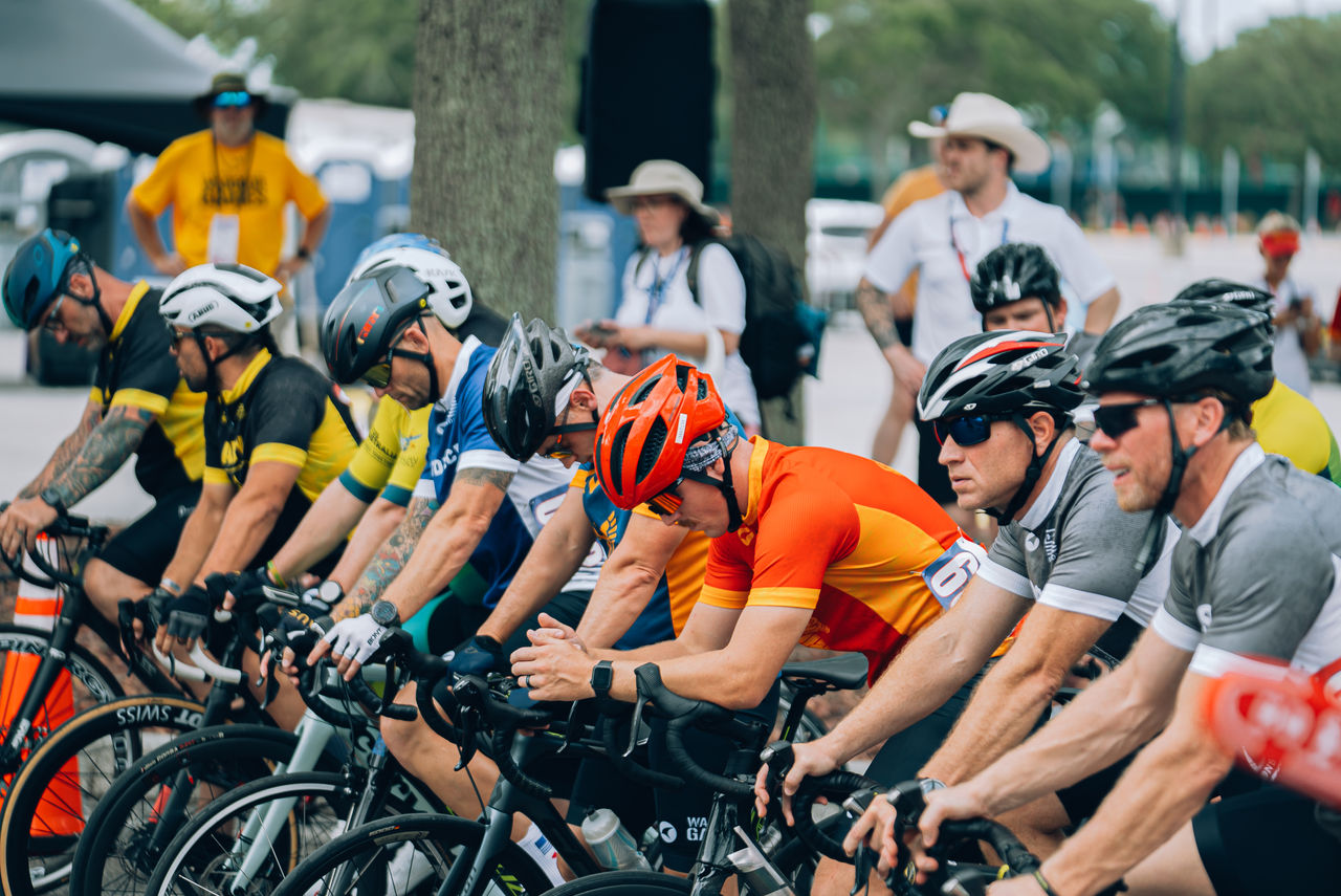 a bunch of people on bicycles ready to start a race