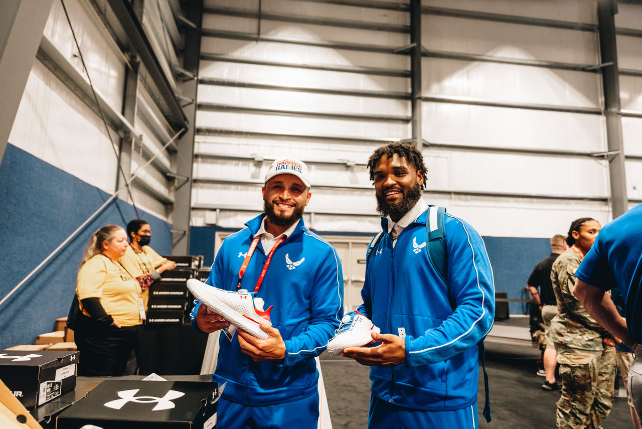 Two men holding sneakers