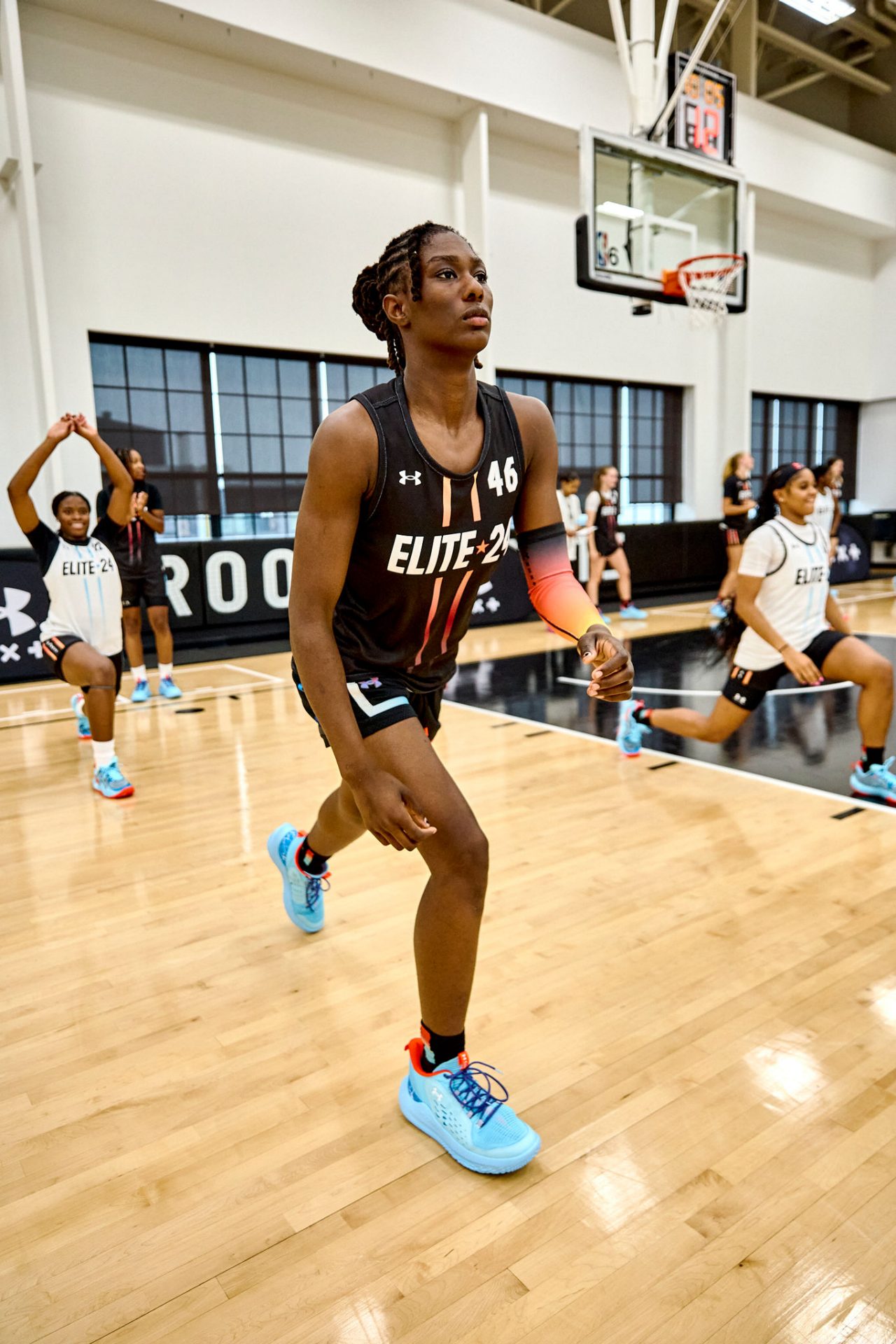 girl stretching on court