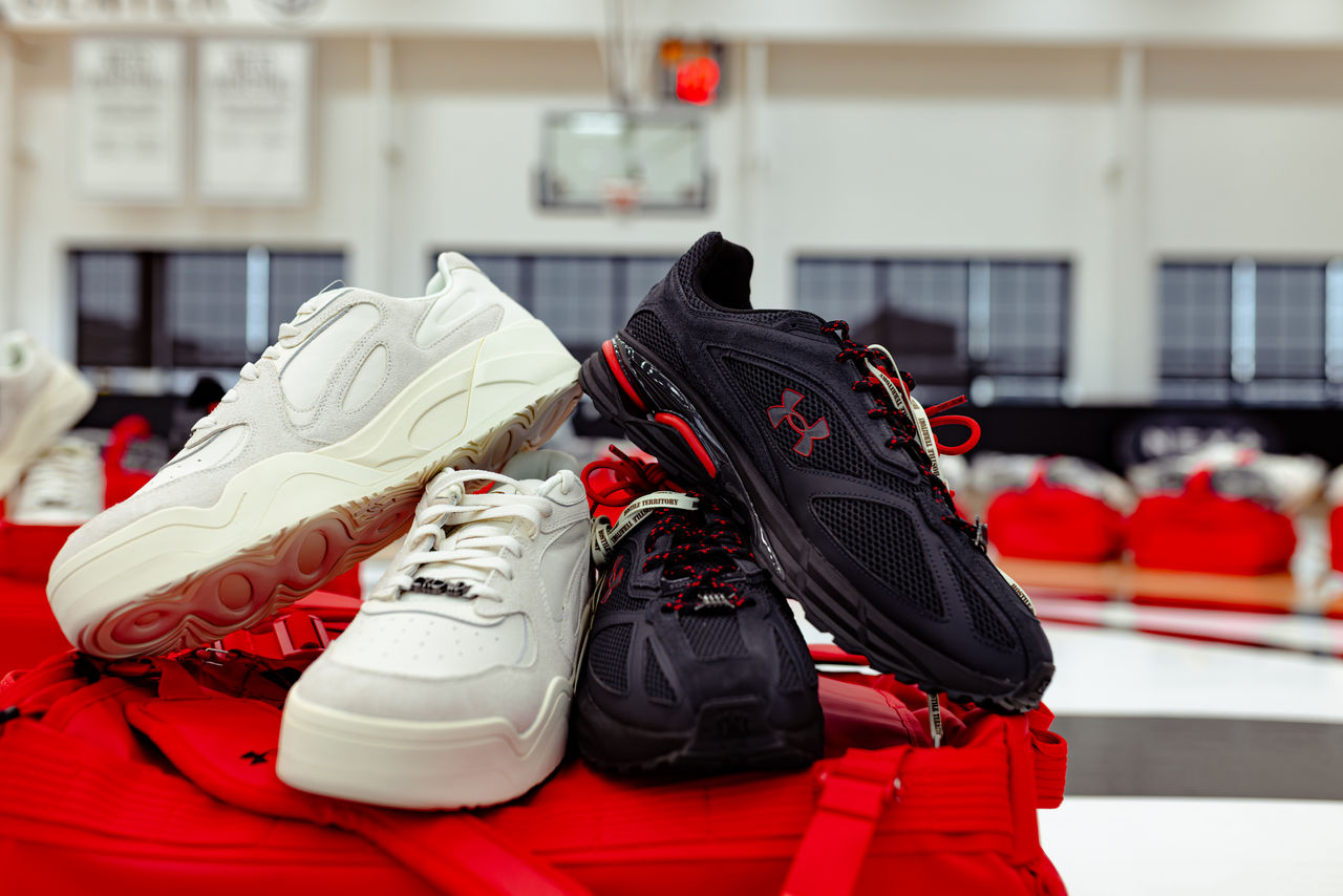 two pairs of sneakers stacked on top of one another