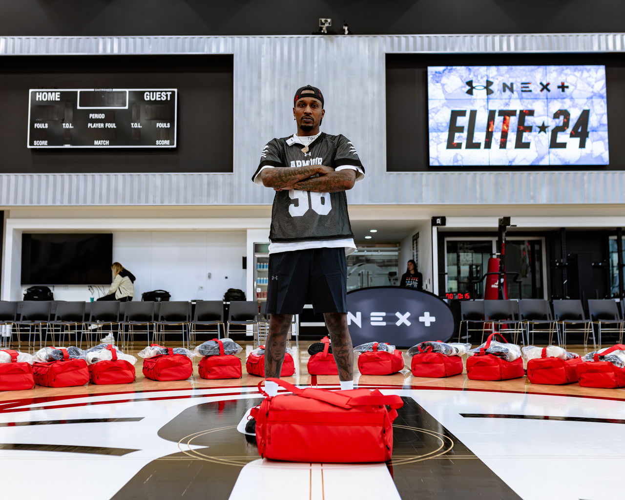 Man standing with his hands crossed on a basketball court