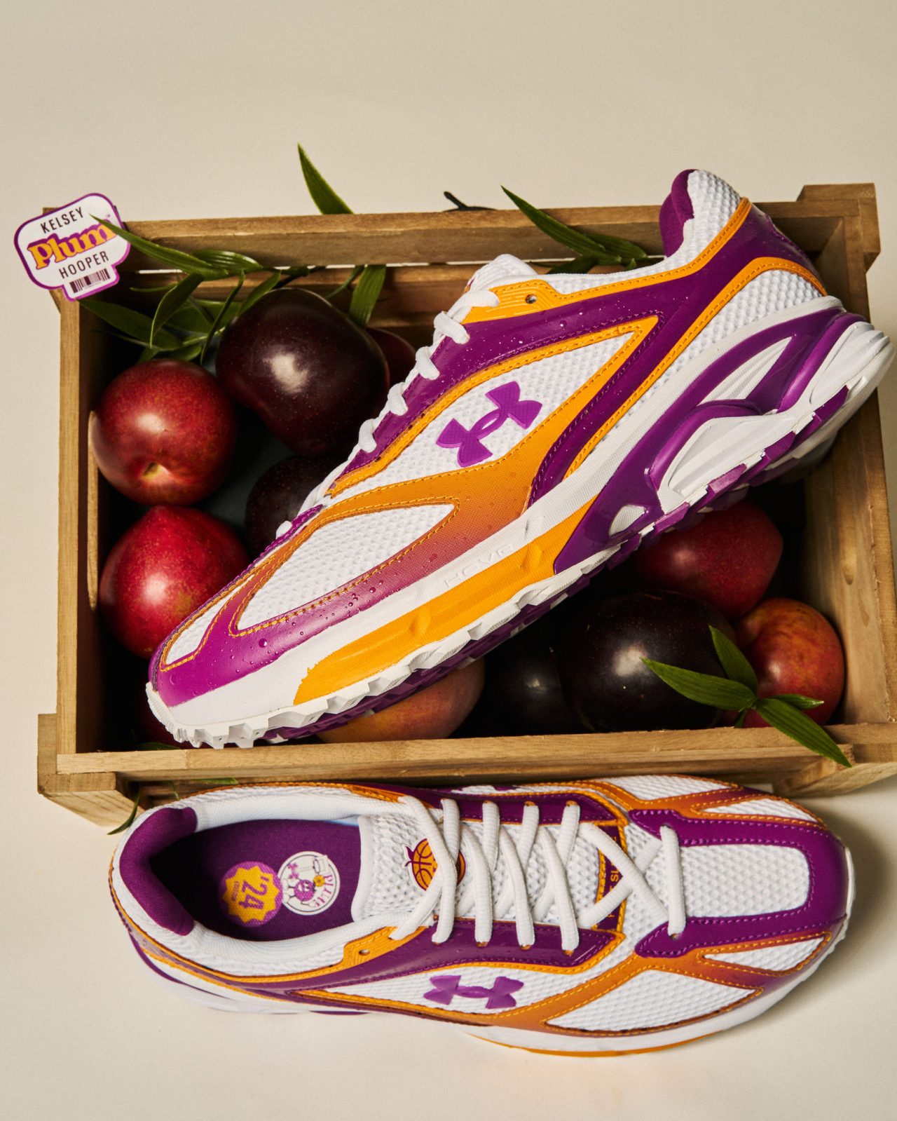 a crate with plums and sneakers