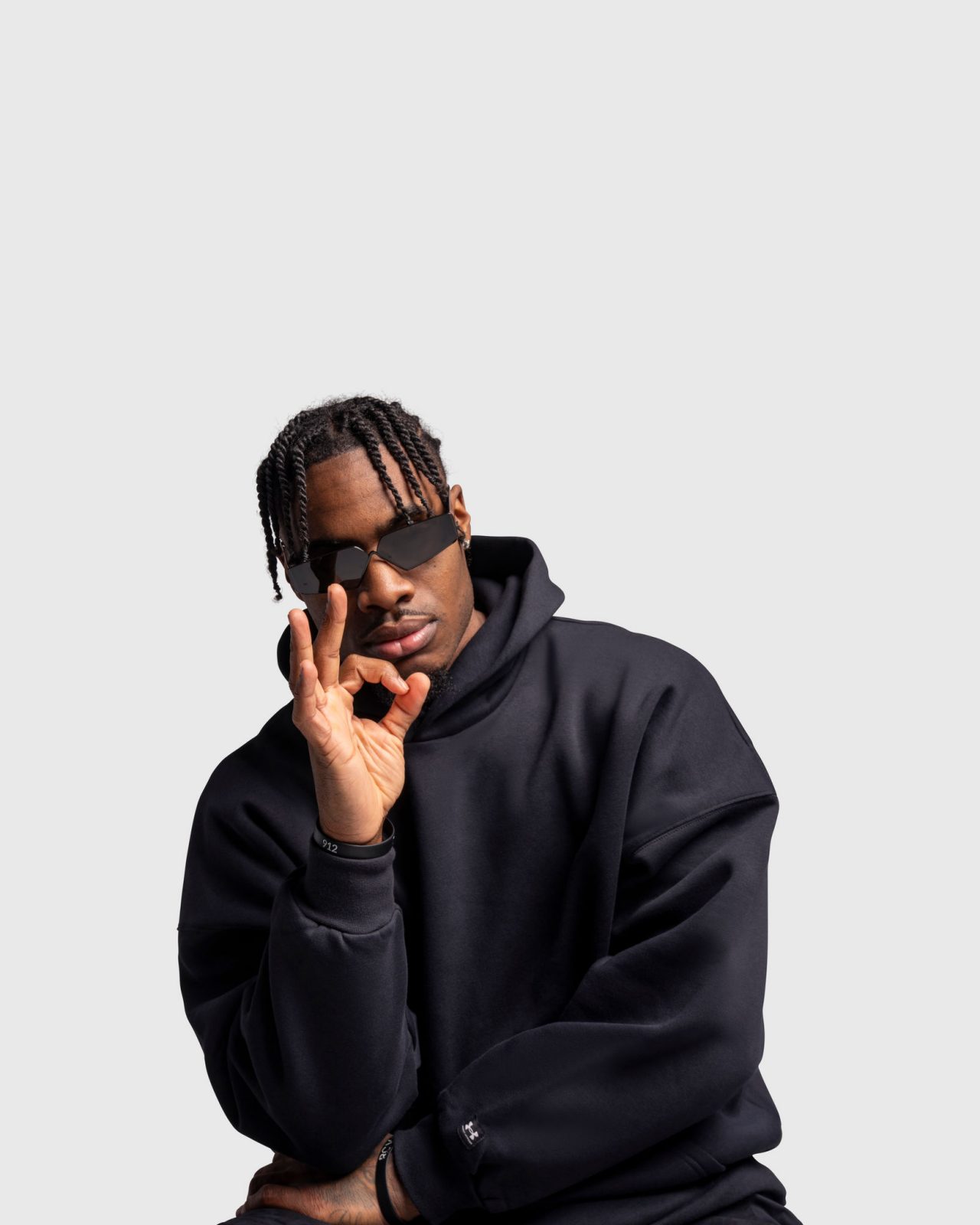 Davion Mitchell in a black hoodie with three sign